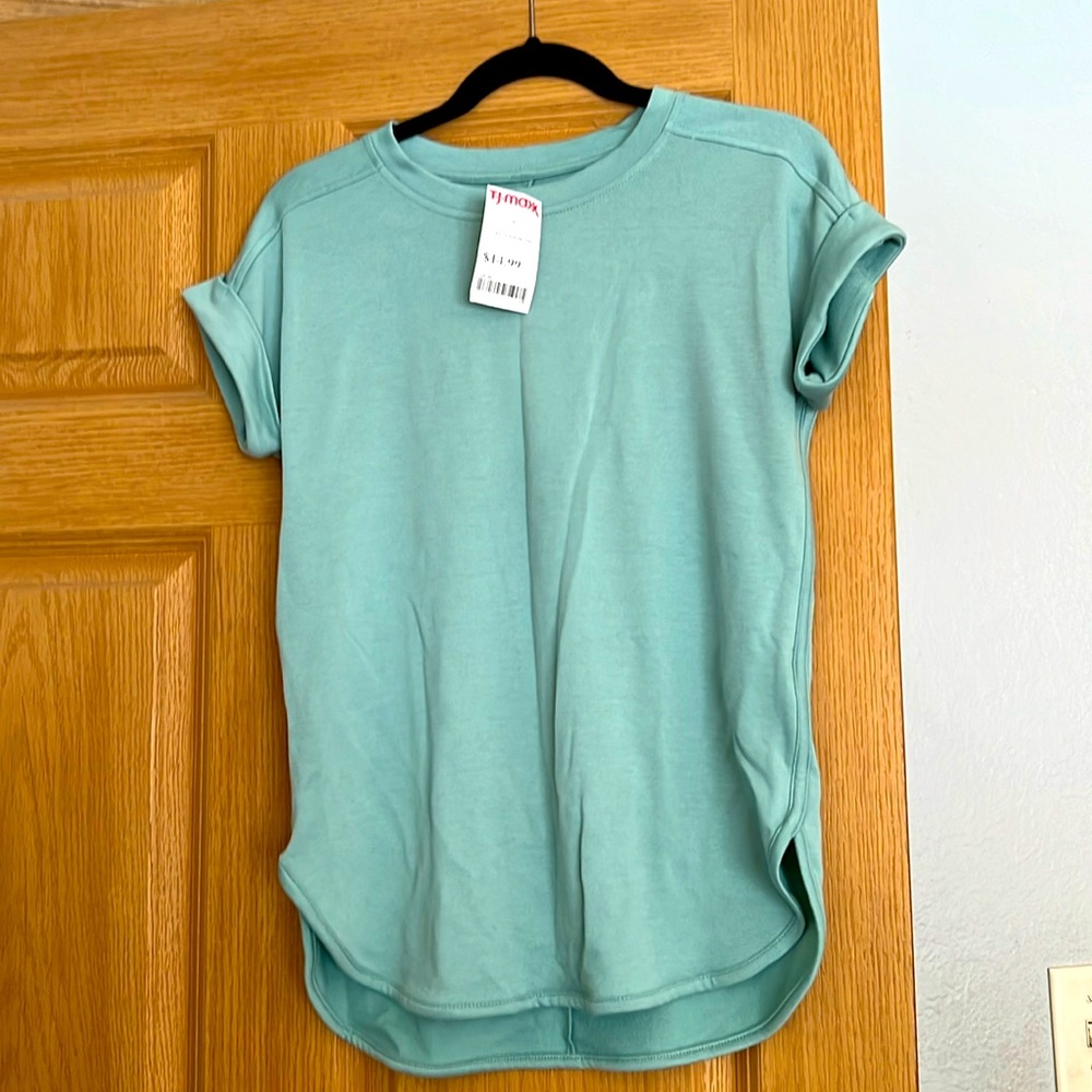 Cute New with tags short sleeve shirt. Pale green in color. Never worn.